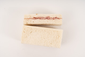 Sandwich made by white bread, ham and mayonnaise on white background.