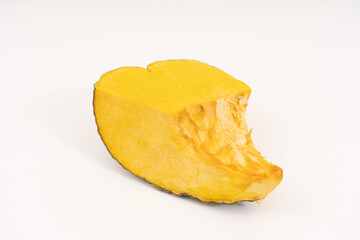 Slice of Japanese pumpkin on white background.