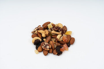 mixed nuts (Peanuts, pecan, walnuts, almonds, hazelnuts, dried raisin and cashews) on white background. Snack concept.
