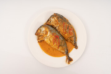 fresh Mackerel Thai food style with Dried Red Curry and Coconut milk Sauce, Chuchi mackerel, curry-fried fish on white background.