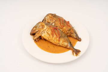 fresh Mackerel Thai food style with Dried Red Curry and Coconut milk Sauce, Chuchi mackerel, curry-fried fish on white background.