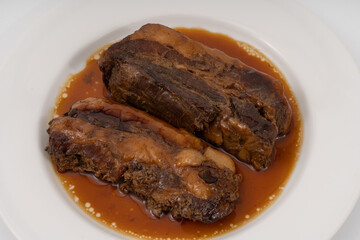 braised pork belly in a sweet soy sauce Japanese styles on white background.