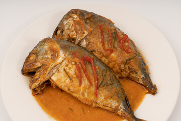 fresh Mackerel Thai food style with Dried Red Curry and Coconut milk Sauce, Chuchi mackerel, curry-fried fish on white background.