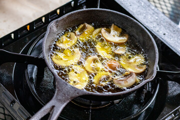 Image of an oiled pan and mushroom taken from an angle