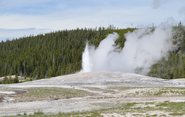 Late Spring in Yellowstone National Park: Old Faithful Geyser Eruption Winds Down in the Upper...