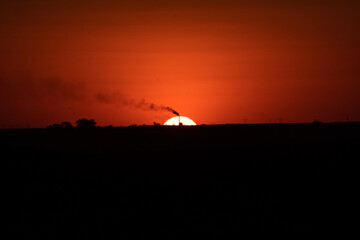A cane factory cutting the sun in half.