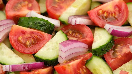 vegetables salad with tomatoes, cucumber, red onion close up