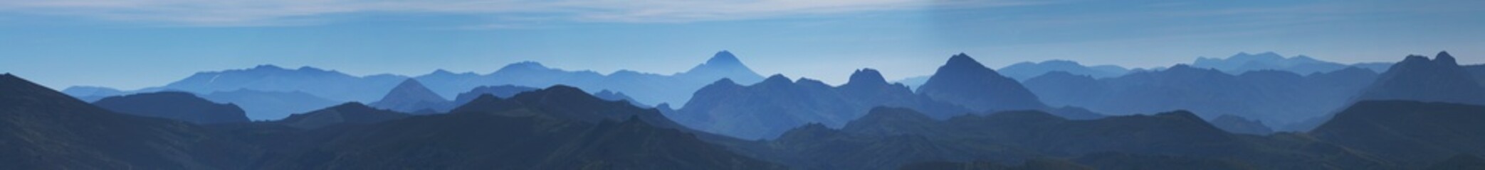 Panoramic of layers of mountains with a predominant blue color.