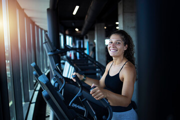 Fototapeta na wymiar Sportswoman or athlete smiling on training while running on treadmill machine in the gym. Happy and positive people workout.