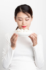 The girl holding the dumpling in her hand