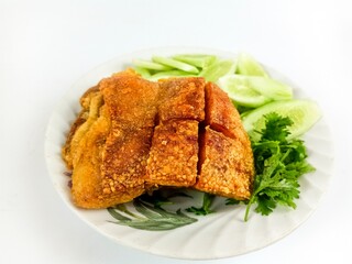 The crispy pork serve with fresh vegetable photo on the white background
