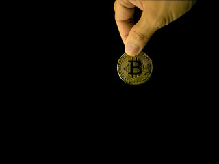 Plakat Human holding gold bitcoin photo on the simple color background with clipping path