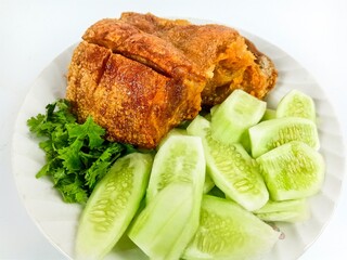 The crispy pork serve with fresh vegetable photo on the white background