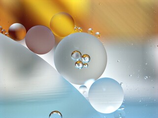 abstract background with yellow gold bubbles oil in water ,macro image ,sweet color for lovely card , blue shiny droplets for web design