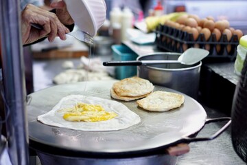 Cooking Roti, Thai pancake with banana and egg. Modefied Indian traditional street food. Thai street food and dessert.