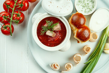 Classic Ukrainian borsch with meat, pamphlet and lard on a white background