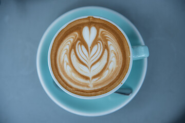 Top view of hot coffee latte in a blue cup 