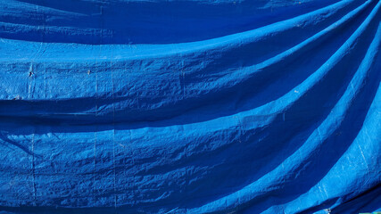 Abstract blue background with waves. Construction industrial cover material