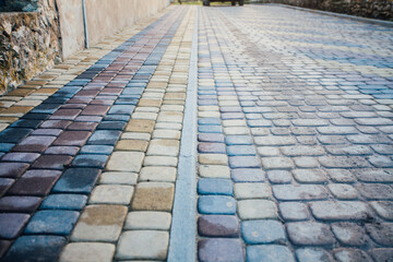 Perspective View Monotone Gray Brick Stone Pavement on The Ground for Street Road. Sidewalk, Driveway, Pavers, green grass