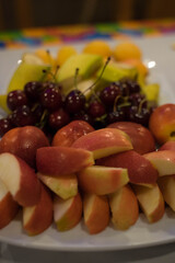 fruits lie on a white plate on the table