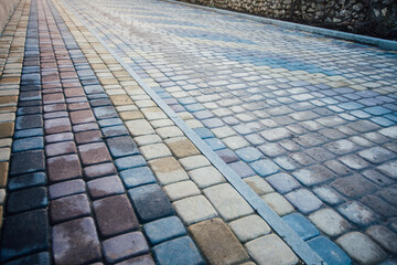 Perspective View Monotone Gray Brick Stone Pavement on The Ground for Street Road. Sidewalk, Driveway, Pavers, green grass