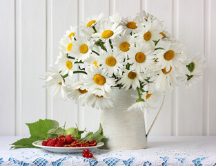 still life with daisies and berries.
