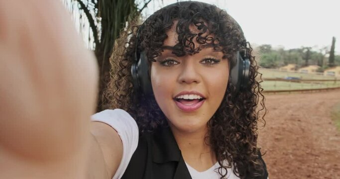 Cute african american girl in a video conference with her cellphone. 4K.