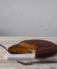 Homemade pumpkin pies.Rustic cooking style. Pumpkin muffin on a white rustic plate with a kitchen napkin and a large pumpkin in the background.