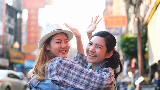 Traveler Asian couple travel in Bangkok, Thailand, sweet couple taking photo  spending holiday trip in sunset. Lifestyle couple travel in city concept.Young fun happy Asian tourist backpacker travel.