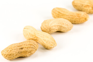 some dried and closed peanuts isolated on white background with copy space