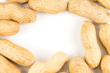 some dried and closed peanuts isolated on white background with copy space