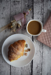french breakfast with coffee and a croissant
