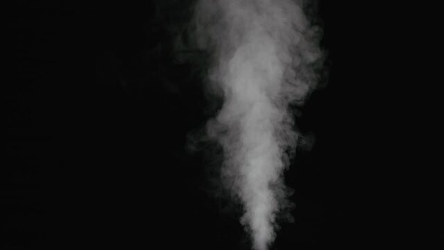 Slow motion thin water mist stream over black background