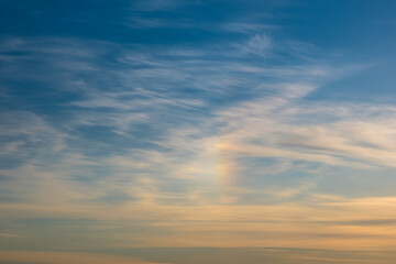 Rainbow and clouds in the sky before sunset.  Golden hour. Natural background..