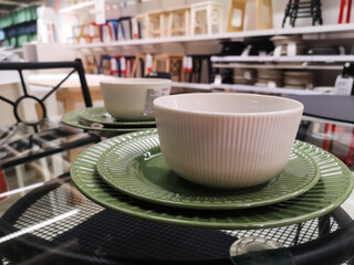 empty white porcelain tea cup with saucers on a glass table