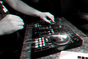 hands DJ playing and mixing music on music controller at a party