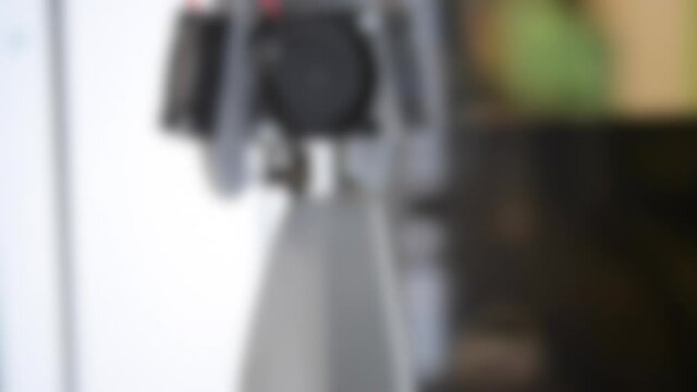 Blurred background. 3d printer building gray abstract object