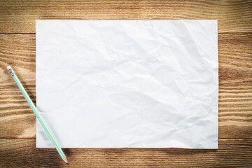 Sheet of paper lying on wooden table