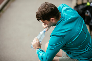 Thirsty athlete. Man having water after a workout.	