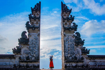 Girl standing on the portal of Lempuyang temple, Bali, Indonesia
