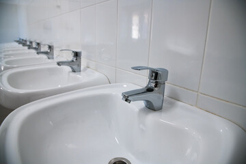 Close-up of row modern ceramic wash hand basins
