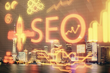 SEO hologram on city view with skyscrapers background double exposure. Search optimization concept.