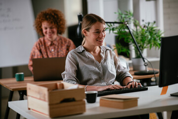 Happy businesswoman working on laptop. Young businesswoman working in the office.