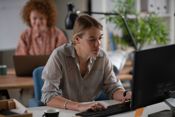 Happy businesswoman working on laptop. Young businesswoman working in the office.