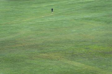 Green lawn of Parade Ground park, view from Holyrood Park in Edinburgh city, Scotland, UK