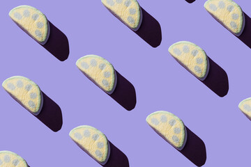 Pattern of delicious marshmallows with hard shadows on a pastel lilac background.
