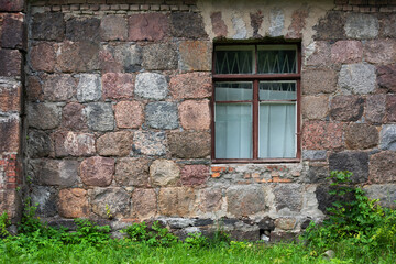 Fototapeta na wymiar Window in stone wall