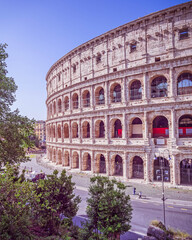Fototapeta na wymiar Rome Italy, impressive view of the Colosseum ancient amphitheater under clear blue sky