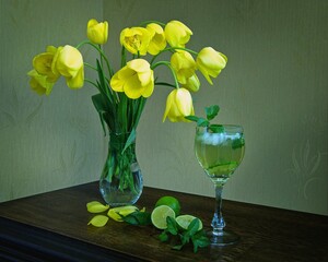 Still life with yellow tulips and mojito cocktail