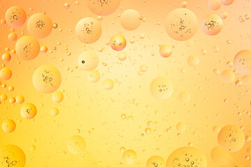 Oil bubbles on water macro photography abstract yellow color background